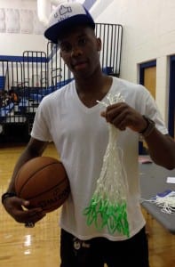 Norris Cole of the Miami Heat, holding up a green hoops dayton net