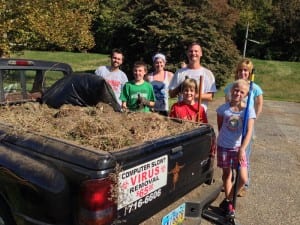 The bed of a pickup truck was filled with dirt and weeds from the court