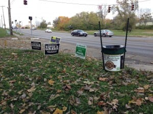 David Esrati puts out trash cans instead of yard signs