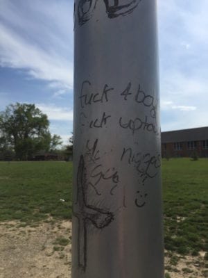Graffiti on the pole on the playground where a 7 year old was stabbed during recess at Residence Park Elementary
