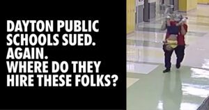 Dayton Public Schools sued again - where do they hire these folks. Photo of man walking kid down hall- holding autistic kid by his ankles.